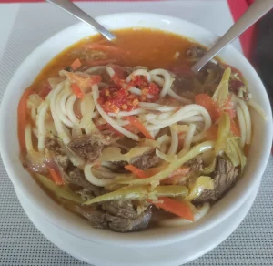 trekker having thukpa, popular meal on EBC trek